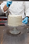 A confectioner decorating a cake