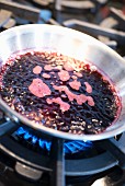 A wine reduction in a pan