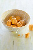 A bowl of orange macaroons
