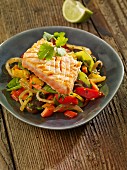 Colourful stir-fried vegetables with grilled salmon