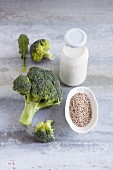 A bottle of milk, sesame seeds and broccoli