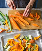 Oven roasted vegetables being made: carrots being chopped