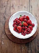 A bowl of fresh strawberries and raspberries