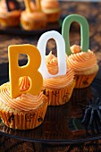 Halloween cupcakes topped with buttercream icing and decorative letters