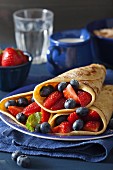 Pancakes with berries and icing sugar