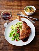 Glazed goose leg with pointed cabbage, chilli pepper, rose hip sauce and a side of potatoes