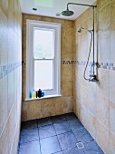 Narrow shower room with window and marble tiles