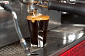 Espresso Pouring From Machine into Two Glasses
