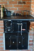 Black, vintage stove integrated in brick counter