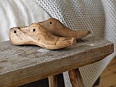 Vintage shoe lasts on rustic wooden bench