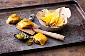 Cheddar raclette with mini chilli burgers, tortilla chips and jalapeños