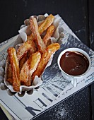 Churros with chocolate sauce (deep-fried choux pastry, Spain)