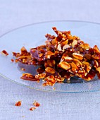 Peanut brittle on a glass plate