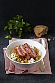Lentil stew with carrots, celery, feta cheese and duck breast