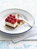 A panna cotta slice with raspberries and honey