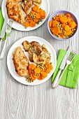 Chicken breast with fried potatoes and a pea and carrot medley