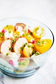Tomato and bread salad with feta cheese in a glass bowl