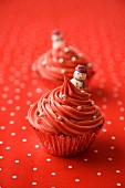 Red Christmas cupcakes decorated with silver pearls and snowmen