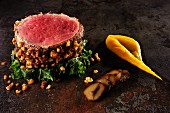 Beef fillet with nuts and green kale