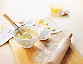 Cake mixture with baking ingredients and a rolling pin