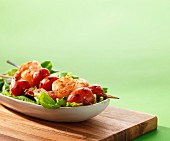 Prawn skewers with tomatoes on a bed of lettuce