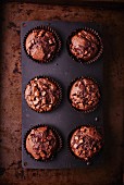 Dark chocolate muffins in the baking tin