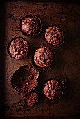 Dark chocolate muffins and one empty paper case