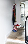 Eames Hang-It-All coat rack in renovated foyer with plain wooden floor
