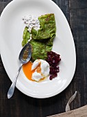 Spinach crêpes filled with eel and poached egg