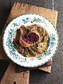 Mixed game in a creamy sauce with baked red cabbage