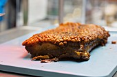 Crispy roast pork on a chopping board