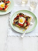 Puff pastry slices with grilled vegetables and fried eggs