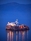 An evening view of the illuminated island of Penon de Alhucemas (Al Hoceima) 300 m off the Moroccan Mediterranean coast (belongs to Spain)