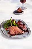 Duck breast on port wine figs and a salad with cranberry vinaigrette