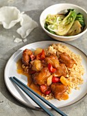 Sweet and sour chicken with fried rice served with bok choy