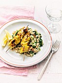 Chicken skewers with almond and spinach rice