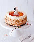 A wedding cake with apricots, cream and flaked almonds