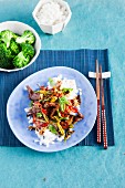 Marinated stir-fried beef with vegetables on a bed of rice