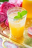 A peach cocktail with vodka and mint