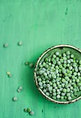 Frozen peas in a green bowl