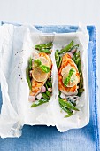 Thai chicken breast with fresh mange tout and coconut milk in parchment paper