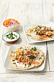 Homemade wheat tortillas with chicken skewers, yogurt, carrots and onions