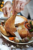 Roast turkey with a herb and pistachio stuffing being carved