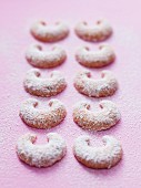 Two rows of vanilla crescent biscuits dusted with icing sugar