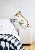Retro table lamp on bedside cabinet with castors