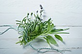 A fresh bunch of herbs featuring sage, rosemary, lavender, chives and savory