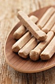 Raw sausages on a wooden plate