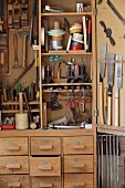 Hand tools in traditional tool cabinet in carpenter's workshop