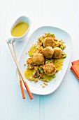 Crab cakes on a bed of red lentils with curry sauce