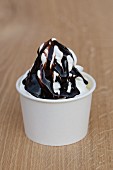 Frozen yoghurt with dark chocolate sauce